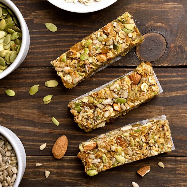 Low carb protein bars studded with seeds and nuts on a wooden surface